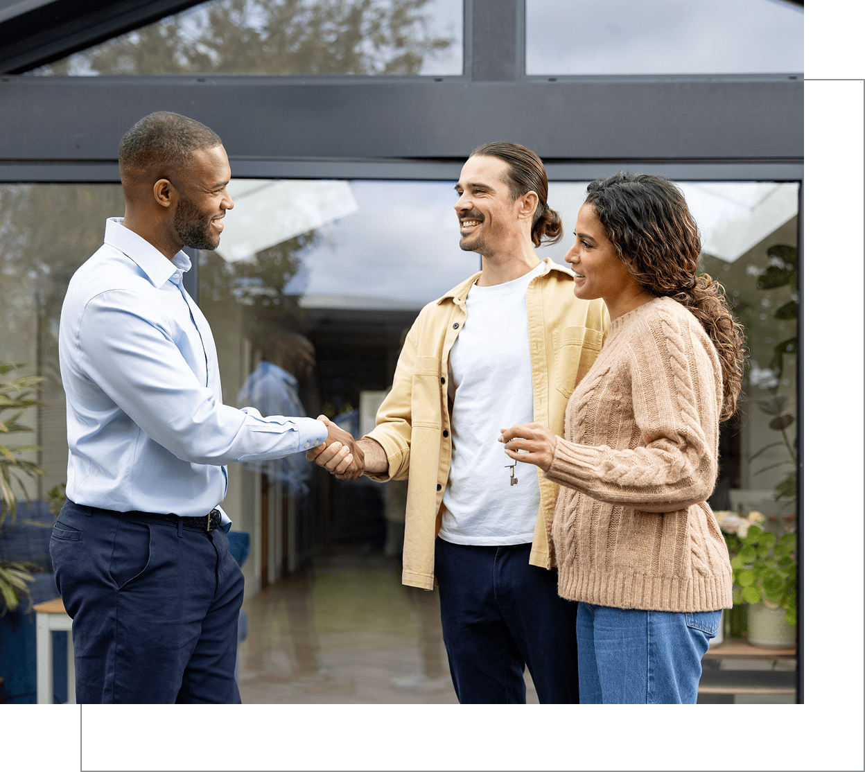 People shaking hands outside a building