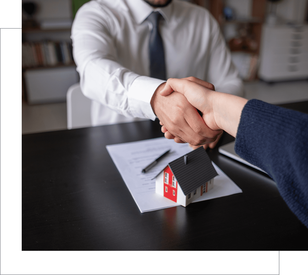 Handshake over house sale documents